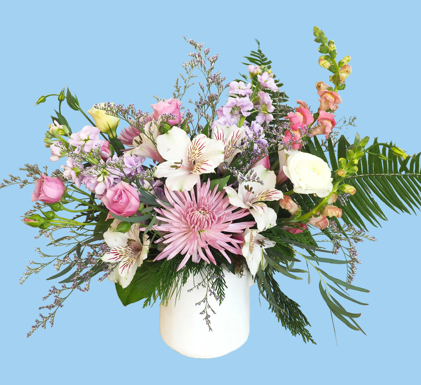 Bouquet of flowers with pink and white flowers in a white vase on a white background